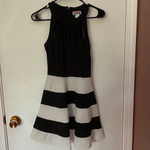 Black and white dress with cutout details on chest and neck area. Size 3
